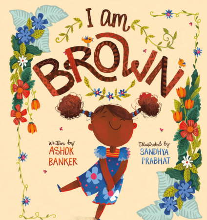 The cover of the children's book I Am Brown, written by Ashok Banker and illustrated by Sandy Prabhat, which features a cartoon happy girl with brown skin and hair