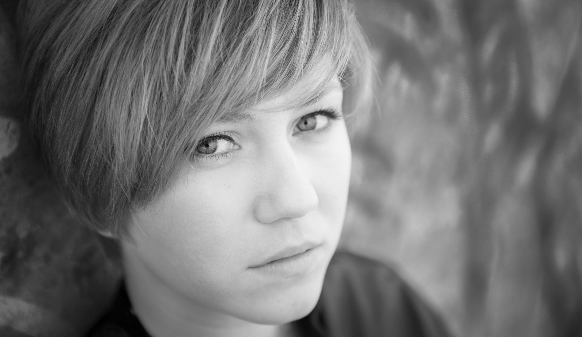 A teenage girl staring at the camera, all alone and looking very serious or unhappy