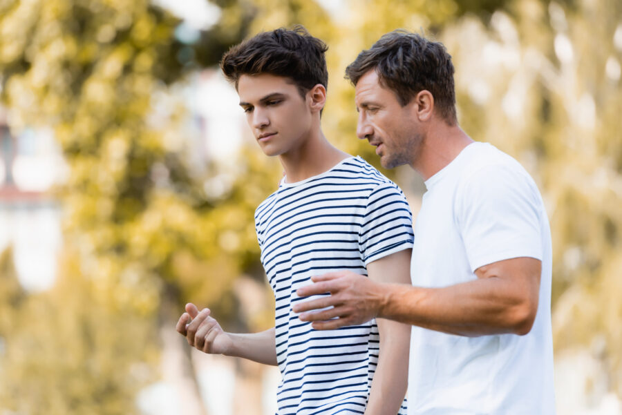 Dad talking to his teenage son
