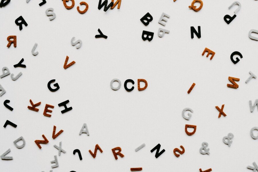 In the center of a board of magnetic letters, the phrase "OCD" is spelled out