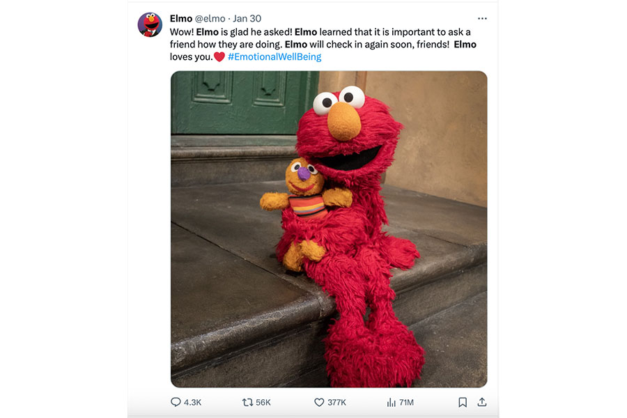 The Sesame Street character Elmo sitting on a step holding his furry stuffed animal, saying, "Wow! Elmo is glad he asked! Elmo has learned that it is important to ask a friend how they are doing."