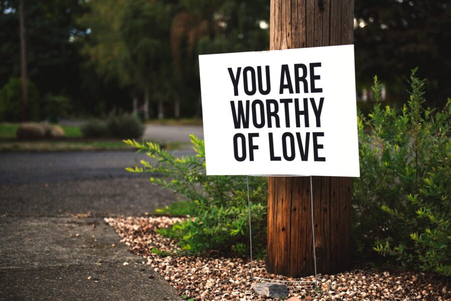 A roadside sign that reads, "You are worthy of love"