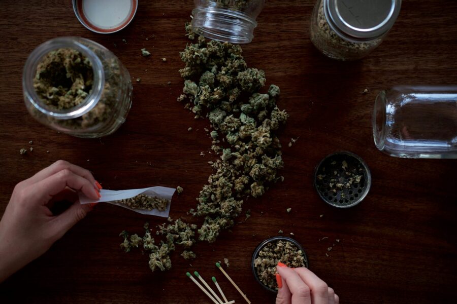A woman rolling cannabis into a joint