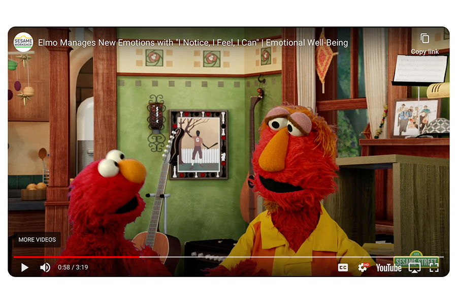 An image of the muppet Elmo and his dad, Louie, talking about their feelings when Louie get frustrated building a bookshelf